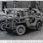 Aidmen unloading wounded at batallion aid station in Italy